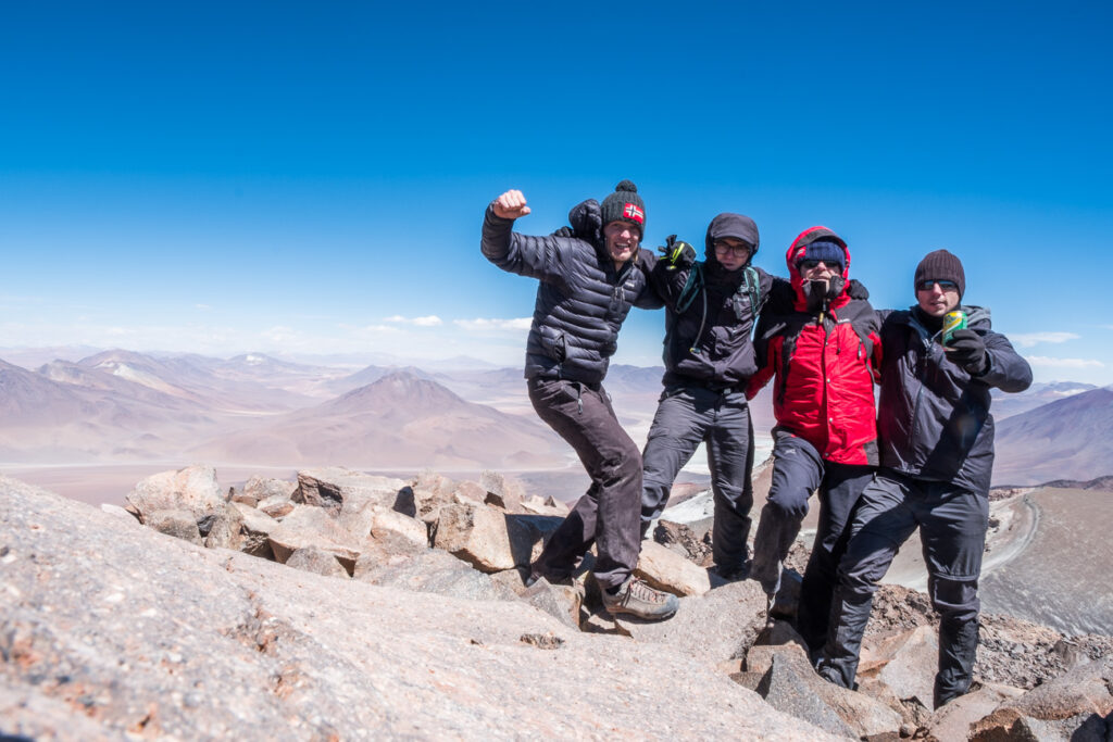 4 people on the summit of the Volcano in Chilean altiplano