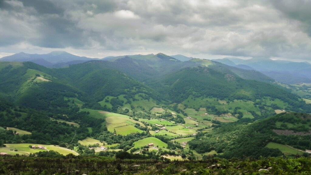 Misty mountaing on Pyrenean haute route with green hills behind