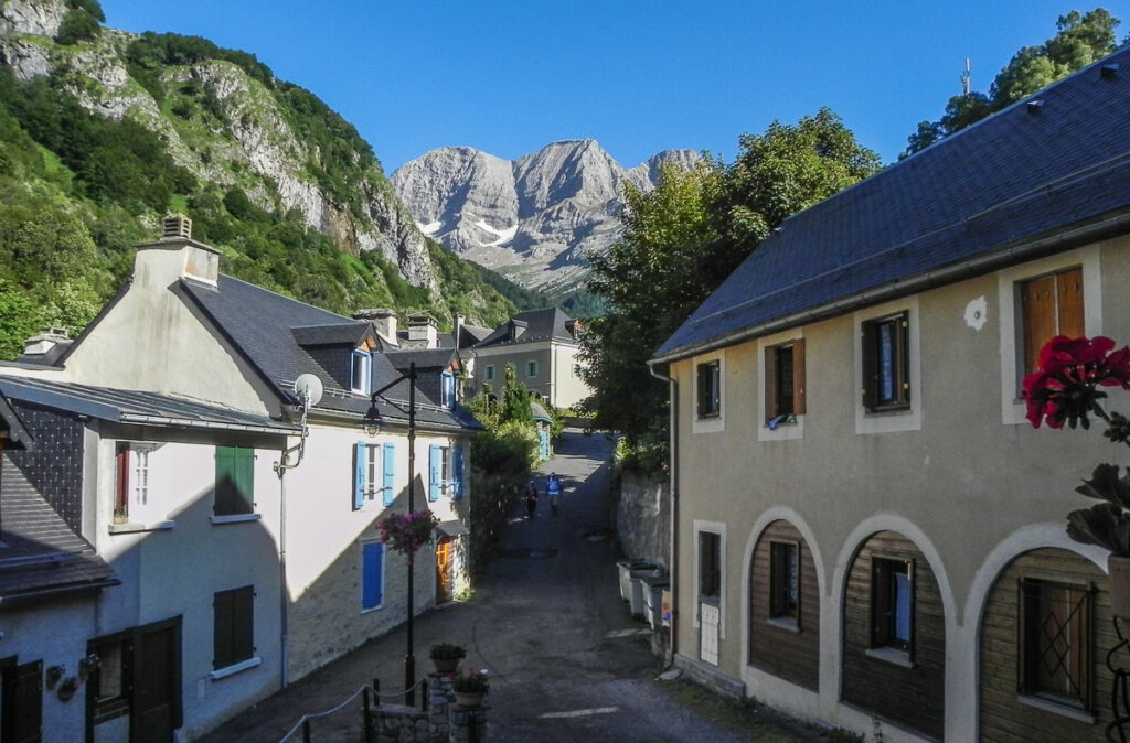 Small Spanish mountain town with majestic rocky mountains in the background