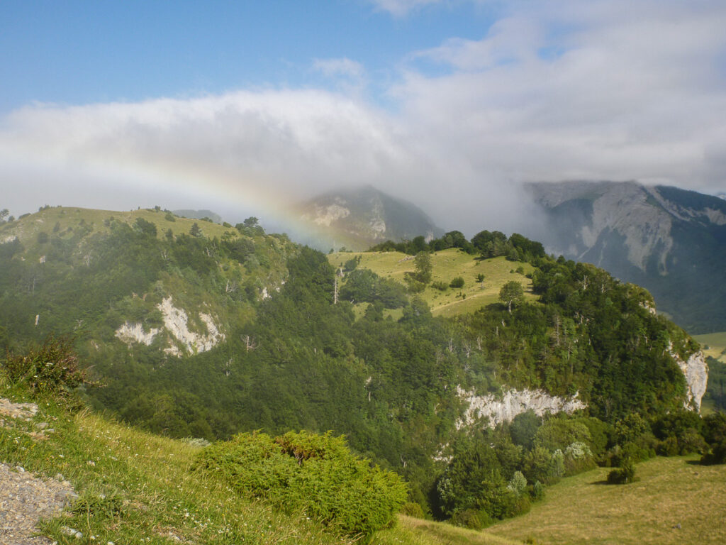 Clouds rolling over the green peaks in Spanish Pyrenees