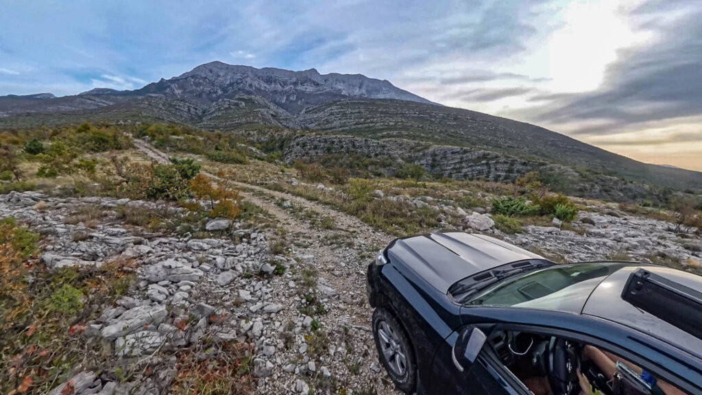 Toyota Landcruiser offroading in the stoney mountains towards the Dinara mountain