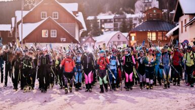 A lots of skimo racer in the starting line with skis on backpacks