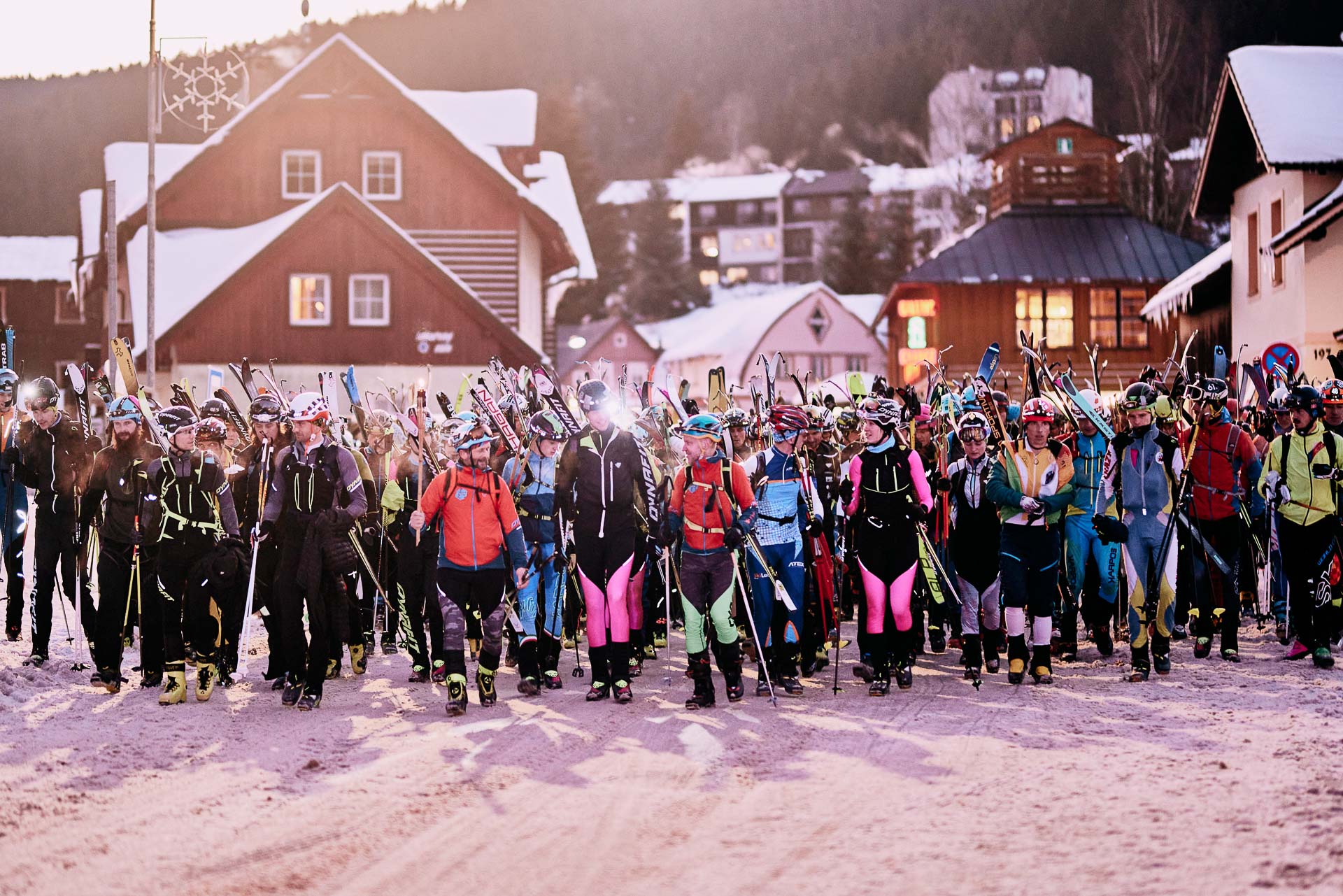 A lots of skimo racer in the starting line with skis on backpacks