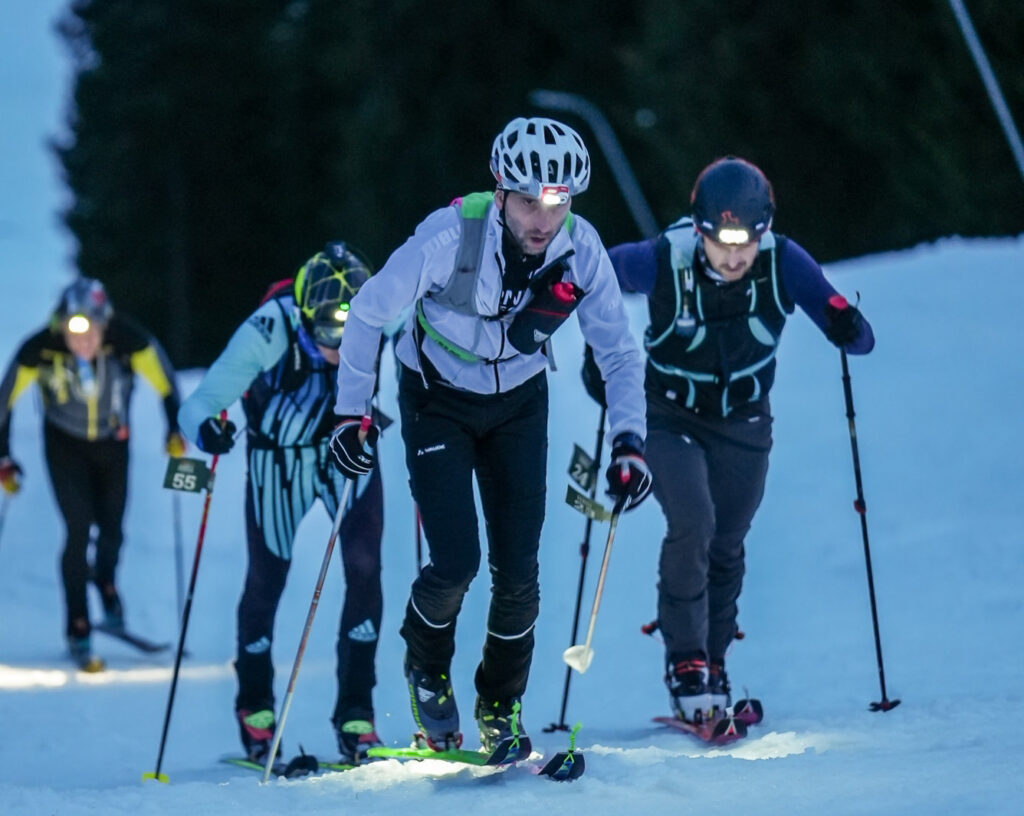 group of three skimo racers ascending the hill on the race Steigfell Metzelei