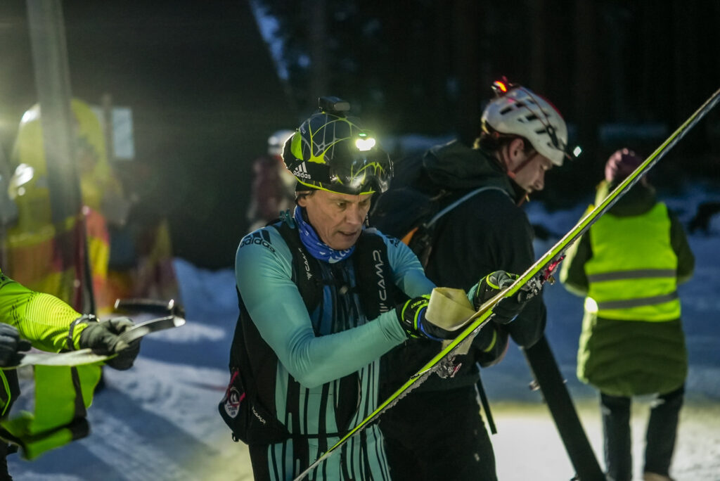 Skimo racer mounting his skins in race depo