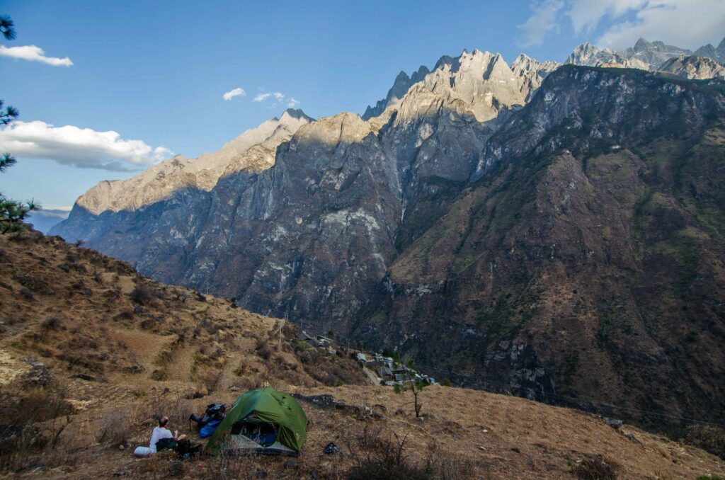 Tent on the slope of the high mountains near tiger leaping gorge