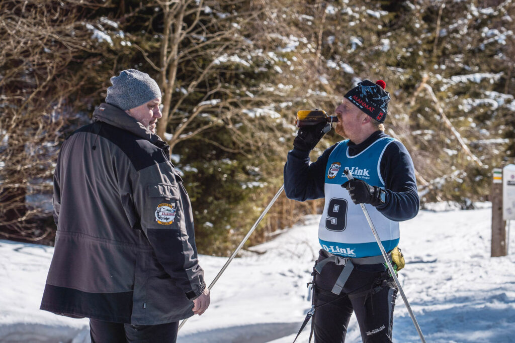 Skier drinking in the finnish of Ledová Jízda race