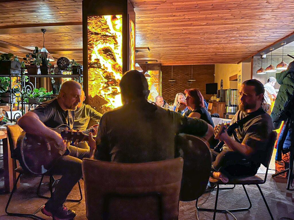 Mushers and skiers playing music and singing in the evening in the restaurant after the race